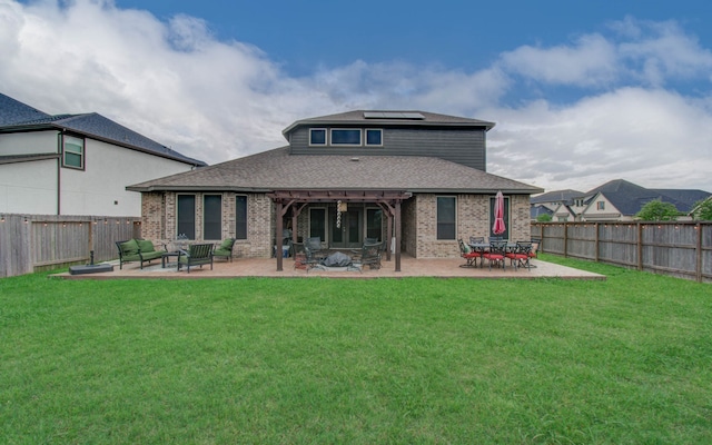 back of house featuring a lawn and a patio