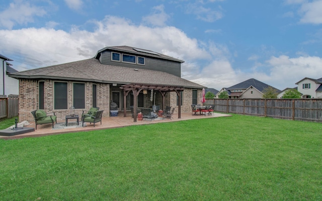 back of house with outdoor lounge area, a lawn, and a patio area