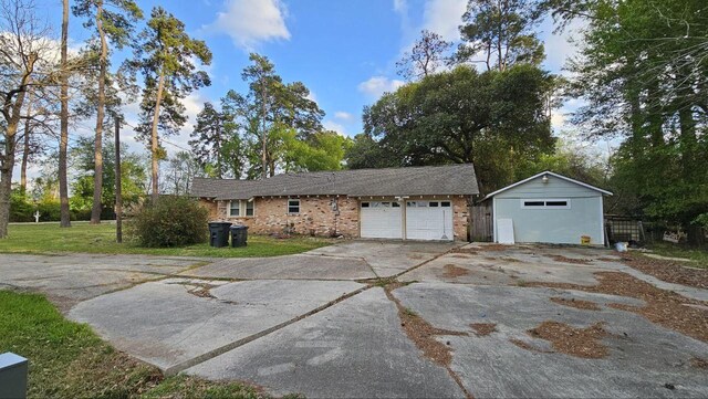 ranch-style home with a front lawn and a garage