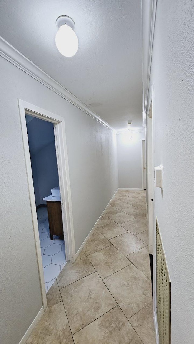 corridor with ornamental molding and light tile patterned floors