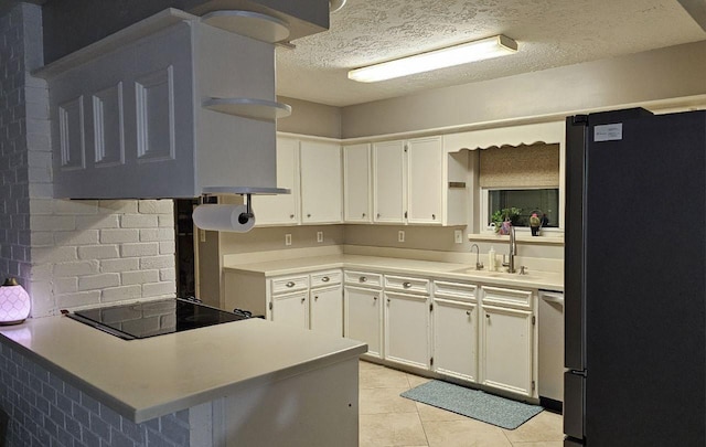 kitchen featuring sink, white cabinetry, refrigerator, black electric cooktop, and dishwasher