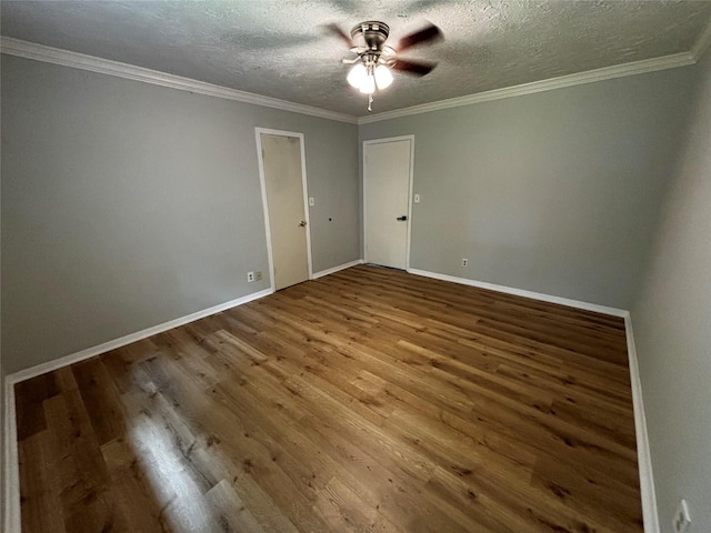 empty room featuring ceiling fan, ornamental molding, hardwood / wood-style floors, and a textured ceiling