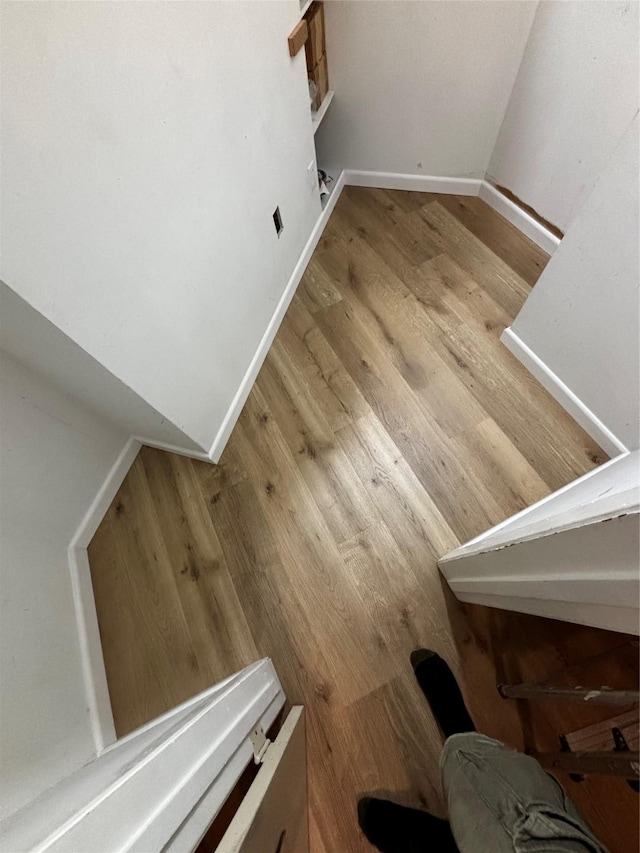 stairs with wood-type flooring