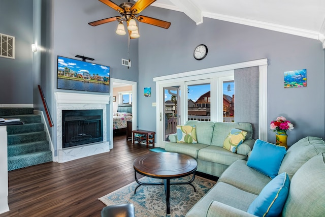 living room featuring ceiling fan, a premium fireplace, beamed ceiling, a towering ceiling, and dark hardwood / wood-style floors