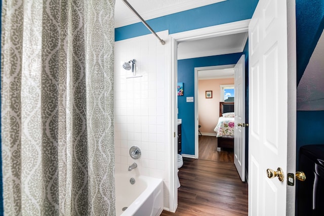 bathroom with shower / tub combo with curtain, toilet, hardwood / wood-style flooring, and ornamental molding