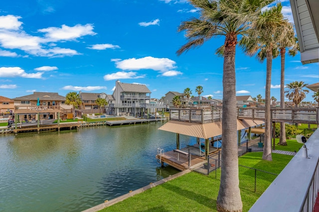 dock area with a water view and a yard