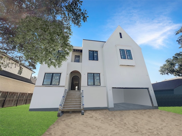 view of front of house with a front yard and a garage