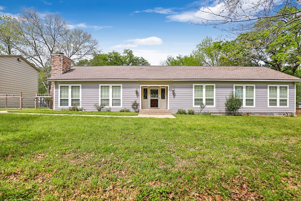 ranch-style home with a front lawn