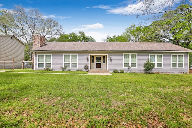 ranch-style home with a front lawn