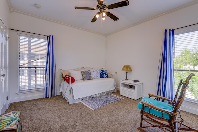 bedroom featuring ornamental molding, light colored carpet, and ceiling fan