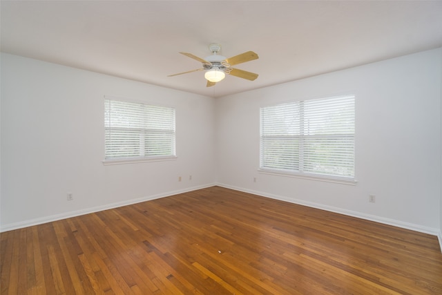 spare room featuring dark hardwood / wood-style floors and ceiling fan