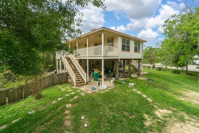 back of house with a yard and a patio