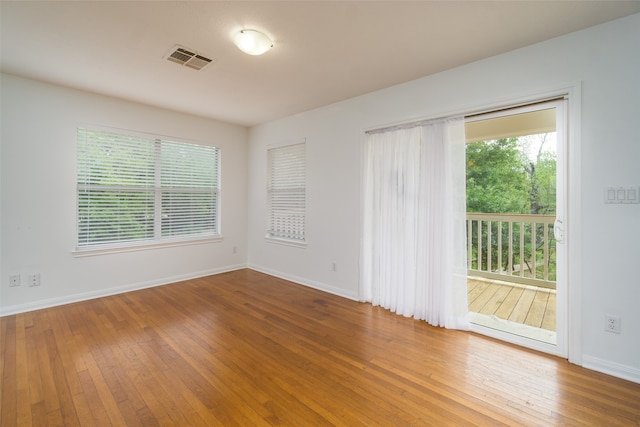 unfurnished room with hardwood / wood-style flooring