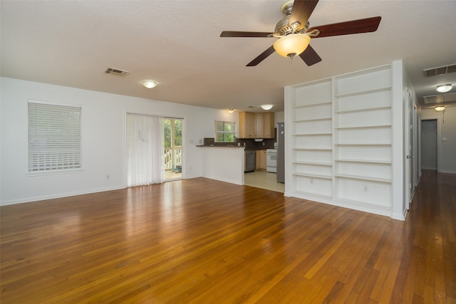 unfurnished living room featuring a textured ceiling, ceiling fan, and hardwood / wood-style flooring