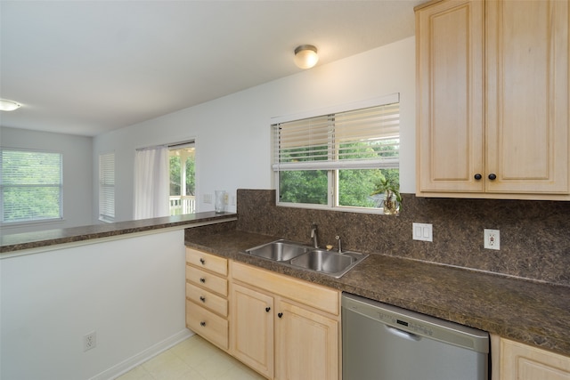 kitchen featuring light brown cabinetry, tasteful backsplash, light tile floors, dishwasher, and sink