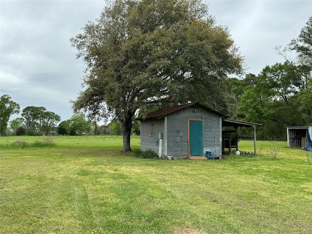 view of outbuilding featuring a carport and an outdoor structure