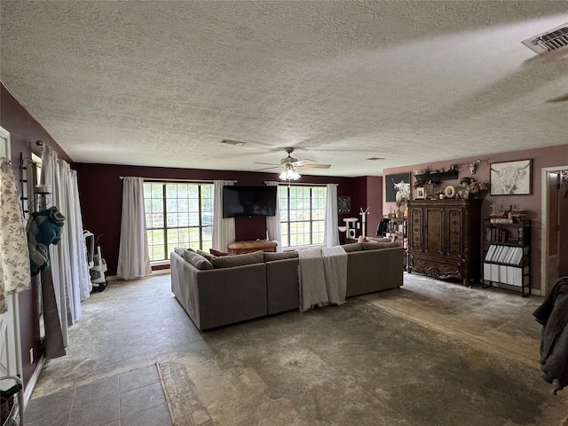 unfurnished living room with ceiling fan, a textured ceiling, and visible vents