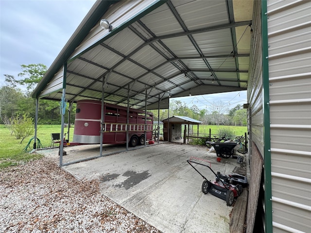 view of parking / parking lot featuring a lawn and a carport