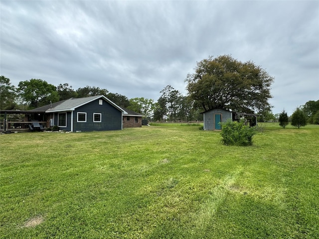 view of yard with a storage shed and an outdoor structure