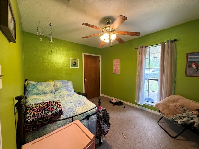 bedroom with carpet flooring, ceiling fan, and a textured ceiling