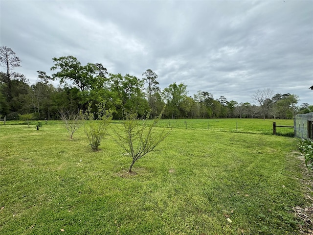 view of yard featuring a rural view and fence