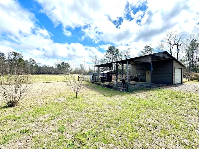 view of yard with a garage and an outdoor structure