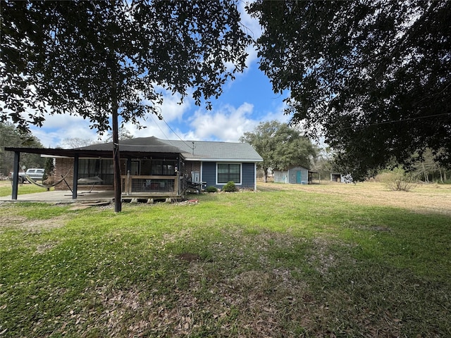 rear view of property featuring a lawn