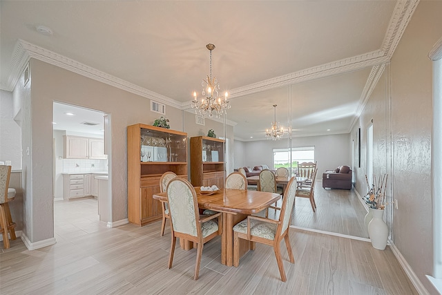 dining area with light hardwood / wood-style floors, a notable chandelier, and ornamental molding