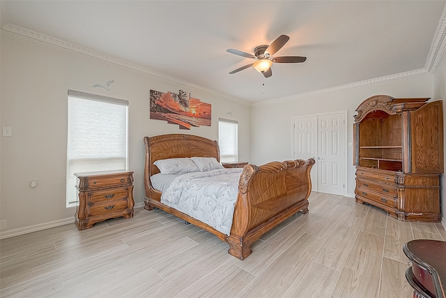 bedroom featuring a closet, multiple windows, light hardwood / wood-style floors, and ceiling fan