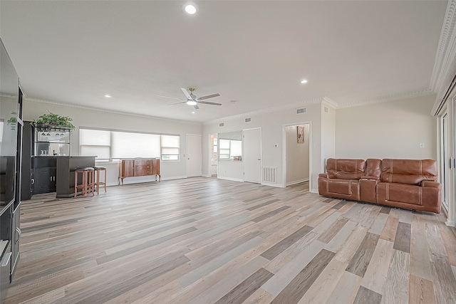 living room with crown molding and light wood-type flooring