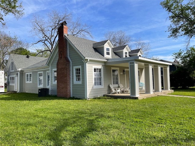 view of front facade with central AC and a front yard