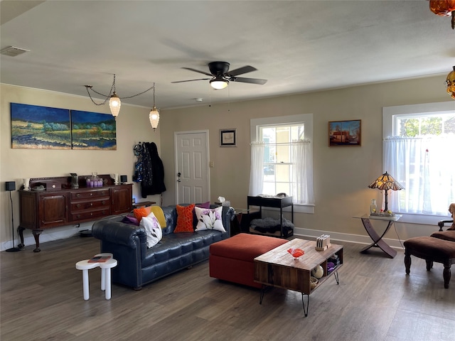 living room featuring ceiling fan, dark hardwood / wood-style floors, and a healthy amount of sunlight