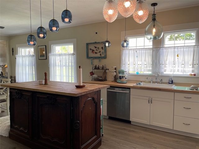 kitchen with white cabinets, light hardwood / wood-style floors, butcher block counters, and dishwasher