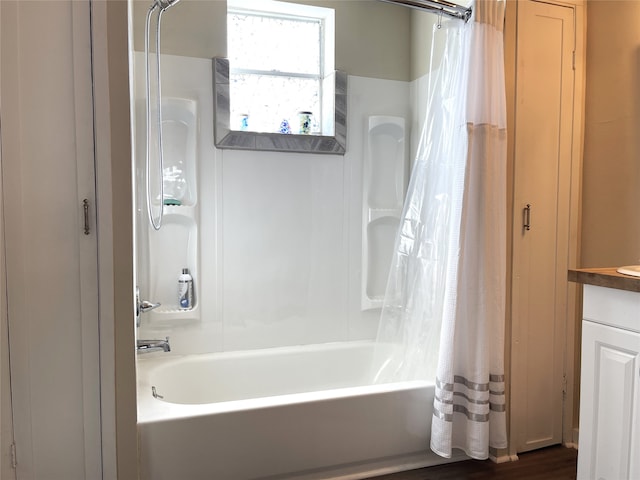 bathroom featuring vanity, shower / bath combination with curtain, and hardwood / wood-style flooring