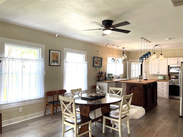 dining room with dark wood-type flooring and ceiling fan