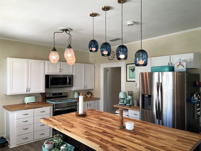 kitchen with white cabinetry, dark wood-type flooring, butcher block counters, and stainless steel appliances