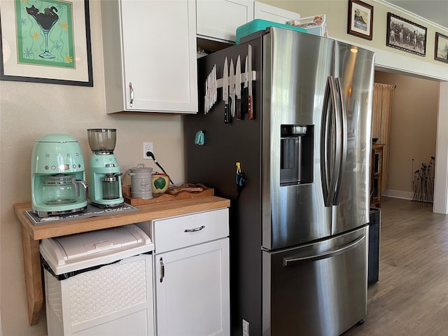 kitchen featuring stainless steel fridge with ice dispenser, white cabinetry, and wood-type flooring