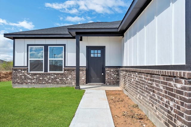 entrance to property with a lawn