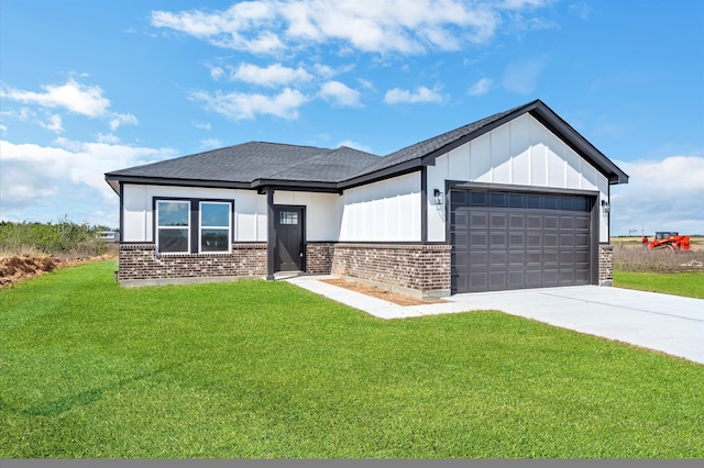 view of front of property with a front yard and a garage