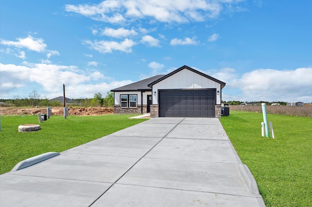 view of front of home with a front lawn and a garage