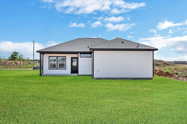 rear view of property with a yard