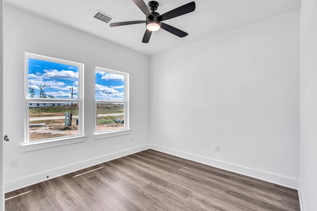 spare room featuring hardwood / wood-style floors and ceiling fan