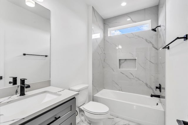 full bathroom with vanity, tiled shower / bath combo, and toilet