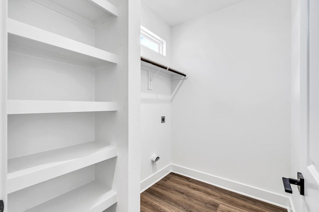 laundry room featuring dark hardwood / wood-style flooring and electric dryer hookup