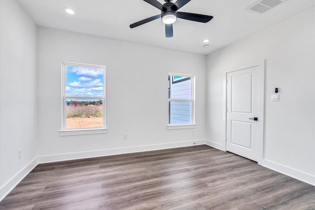 spare room featuring hardwood / wood-style flooring and ceiling fan