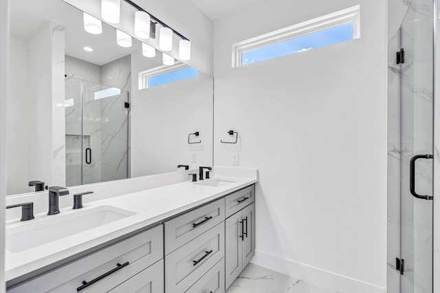 bathroom featuring a shower with door and vanity