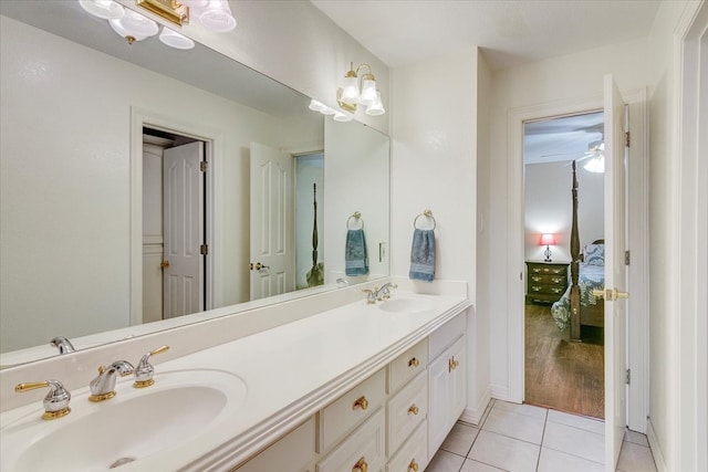 bathroom with dual bowl vanity, hardwood / wood-style floors, and ceiling fan