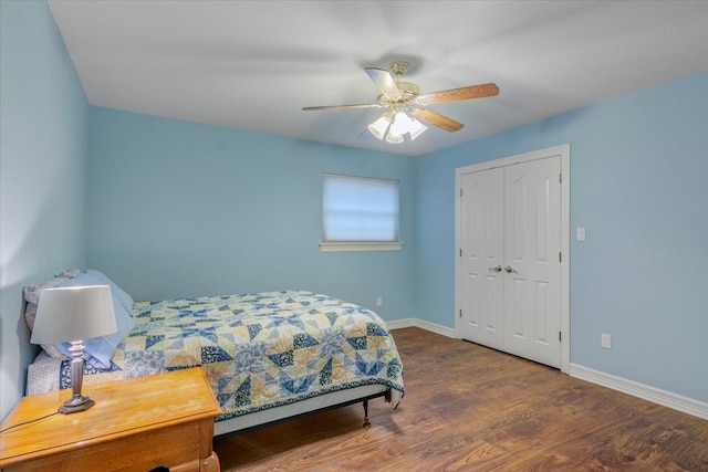 bedroom with dark hardwood / wood-style flooring, a closet, and ceiling fan