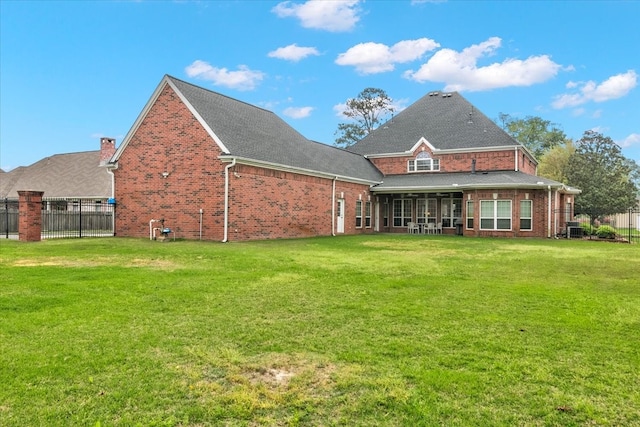 rear view of property featuring a yard