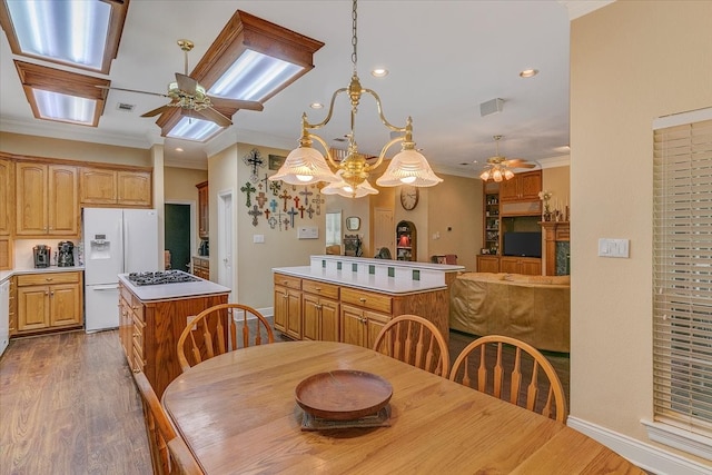 dining room featuring ornamental molding, dark hardwood / wood-style floors, and ceiling fan with notable chandelier